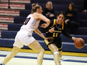 Florence Fortin of the Carleton Ravens keeps in close check with Aneisha Rismond of the Laurentian Voyageurs during OUA basketball action from Laurentian University in Sudbury, Ontario on Saturday, November 12, 2022.