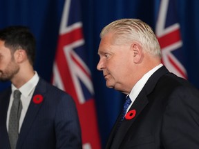 Ontario Premier Doug and Education Minister Stephen Lecce leave after a news conference at Queen's Park in Toronto on Monday. Ford said he is willing to repeal legislation that imposed a contract on 55,000 education workers and banned them from striking, if the workers' union agrees to end a walkout that's shut many schools.