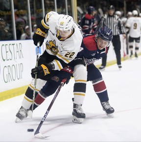 Sandis Vilmanis (22) of Sarnia Sting attempts to pass Joey Willis (14) of Saginaw Spirit in the first period at the Progressive Auto Sales Arena in Sarnia, Ont., Friday, November 11, 2022. Mark Malone/Chatham Daily News/Postmedia Network