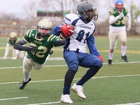 Ursuline Lancers' Caleb Roberts (81) eludes Cole Felhaber (22) of the St. Patrick's Fighting Irish during the LKSSAA senior football final at Norm Perry Park in Sarnia, Ont., on Saturday, Nov. 12, 2022. Mark Malone/Chatham Daily News/Postmedia Network