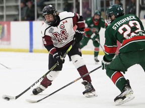 Chatham Maroons' Brayden DeGelas (25) shoots while defended by St. Marys Lincolns' Grayden Strohack (23) at Chatham Memorial Arena in Chatham, Ont., on Sunday, Nov. 20, 2022. Mark Malone/Chatham Daily News/Postmedia Network
