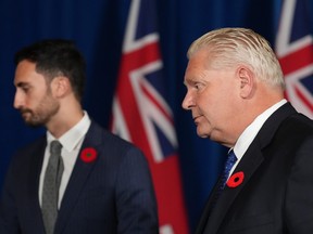 Ontario Premier Doug Ford, right, and Education Minister Stephen Lecce leave after a press conference at Queen's Park in Toronto on Monday Nov. 7, 2022.