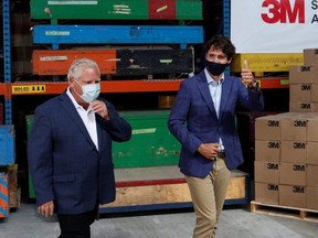 Ontario Premier Doug Ford (left) and Prime Minister Justin Trudeau leave after announcing that the 3M plant in Brockville, Ont., will be making N95 masks, Aug. 21, 2020.