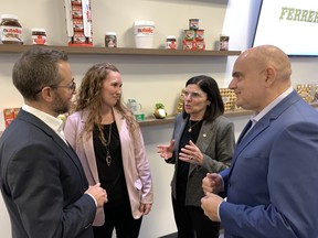 Fabrizio Secco, senior vice president at Ferrero Canada, left, and Laura Wydysz, director of human resources, welcomed Minister Filomena Tassi, from the Federal Economic Development Agency, and Brant MP Larry Brock to a tour of Brantford's Ferrero plant Friday as the minister announced new funding to assist with further automating the plant and adding jobs.