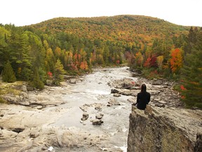 The Goulais River was at peak leaf when we were there in October. Here, Lynn enjoys some quiet time on one of the face rocks overlooking Whitman Dam Falls.