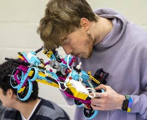 Zach Hunter, 17, a 12th grader at Saunders High School, is studying steering two gears that mark the beginning of their formation. (Mike Hensen / Postmedia Network)