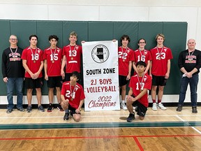 The St. Michael's Dragons Volleyball team stands with their 2022 Championship banner after winning the title on Nov. 5.
(Front row, left to right) Jess Lu and Andrew Tang. (Back Row) Gavin Bonertz (coach), Justin Vanee, Talon Snow, Kenai Warkentin, 
Corbin Holloway, Declan Harrigan, Blaze Wolsey and Scott Harrigan (coach).