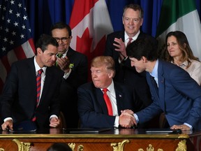 Mexican President Enrique Pena Nieto (L), US President Donald Trump (C) and Canadian Prime Minister Justin Trudeau are pictured after signing a new free trade agreement in Buenos Aires, on November 30, 2018, on the sidelines of the G20 Leaders' Summit.
