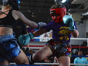 Brianna Rudy (right) delivers a kick against her opponent at Bellegarde's Dragons home tournament on November 19. The club saw hundreds attend to both participate and spectate throughout the day.