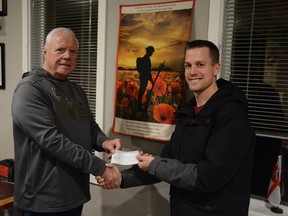 My Garage owner Chris Dekker (right) presents Legion President Keith Shaw with a check for $2,700 of funds raised from tire swaps that the business conducted on Remembrance Day.