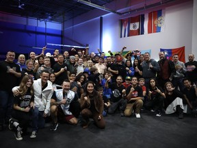 Bellegarde's Dragons team members, Palombo family members, and other fans and supporters at Trial by Fire 12 take a celebratory group photo with Anthony Palombo (centre) after his huge victory, winning the WKA North American Champion title for 140 lbs. fighters on November 25.