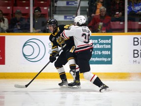 Colby Barlow and Ty Voit tussle along the boards in front of Carter George in the first period as the Owen Sound Attack host the Sarnia Sting inside the Harry Lumley Bayshore Community Centre on Wednesday, Nov. 9, 2022. Greg Cowan/The Sun Times