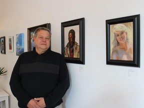Downtown Belleville businessman, Chris Finkle, stands in front of his art exhibit at the Quinte Arts Council Gallery on Bridge Street, which opened Thursday evening and runs until December 8. JACK EVANS PHOTO