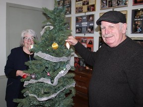 Belleville Theatre Guild officials Cyndi Lucas, left and Jim
Love, house chair, pitch in to decorate a tree in the theatre's "green room," downstairs from the stage. JACK EVANS PHOTO