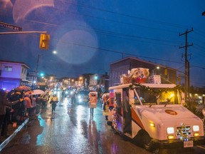 Members from Canada Post collect letters to Santa from parade attendees during the Trenton Santa Claus Parade on a rainy Sunday evening. ALEX FILIPE