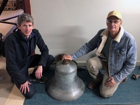 Ian Summers (left), principal of Delhi Public School, and Dave Rusnak., of Delhi, pose with a school bell that dates back to 1900. It was transported from a storage building in Brantford to the Delhi Tobacco Museum and Heritage Centre. Submitted