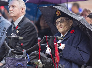 Betty Jo Bryson, who served in the RCAF during peace time watches the Remembrance Day service on Friday November 11, 2022 at the Brant County War Memorial in Brantford, Ontario. Beside her is Memorial Cross recipient Rick Leary, whose son Capt. Richard (Steve) Leary was killed in Afghanistan. Brian Thompson/Brantford Expositor/Postmedia Network