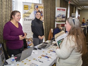 Nicole Townsend (left), HR assistant and Leanne Corbett, HR manager at Mitsui High-Tech (Canada) Inc. speak with Melissa Dalton of Brantford on Tuesday November 15, 2022 during the Grand Erie Aspire Job Fair held at the Best Western in Brantford, Ontario.
