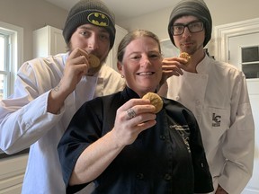 Carolyn Freeman, a chef and staff member of Why Not City Missions, tries a peanut butter cookie baked in the kitchen at Charlie's Place. She is joined by Jason Arnott and Liam Bock, residents of Charlie's Place, a home for at-risk young men looking to make changes in their lives. SUBMITTED