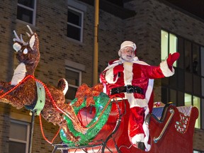 Santa waves to people lining Dalhousie Street in downtown Brantford on Saturday during the first Santa Claus parade since 2019.