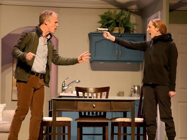 Roger (Rod Jones) confronts an intruder (Katie Verheoven) in a scene from the Brockville Theatre Guild's Love and Avarice. (RONALD ZAJAC/The Recorder and Times)