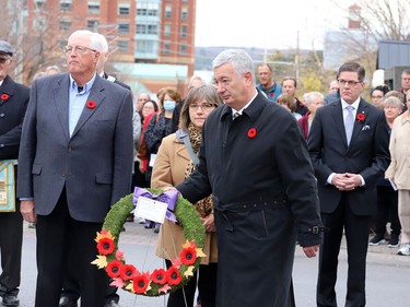 Outgoing Brockville Mayor Mike Kalivas heads to the cenotaph to lay a wreath on behalf of the city, while Mayor-Elect Matt Wren stands at right. From left are Couns. David Beatty and Nathalie Lavergne. (RONALD ZAJAC/The Recorder and Times)
