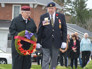Reg McIlvenna is accompanied by Dan Davis of Royal Canadian Legion Branch 97 as the war veteran places the Government of Canada wreath during the Remembrance Day ceremony at Fort Wellington in Prescott on Friday.
Tim Ruhnke/Postmedia Network