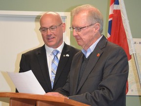 Edwardsburgh Cardinal Mayor Tory Deschamps (left) reads the oath of office as retired senator and long-time MPP Bob Runciman looks on during the inaugural meeting of the new term of township council on Monday morning. The gathering was relocated from the council chamber to the Spencerville fire hall to accommodate a larger audience.
Tim Ruhnke/The Recorder and Times/Postmedia Network