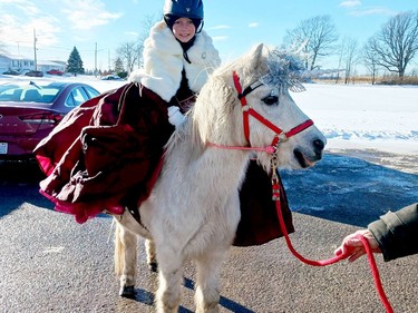 Vaida Watkins with Theo the horse at the Santa Claus parade in Lansdowne on Sunday afternoon. (KEITH DEMPSEY/Local Journalism Initiative)