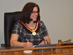 Leeds Grenville Warden Nancy Peckford looks up as she signs the confirmatory bylaw at the end of the inaugural meeting of the new four-year term of counties council on Wednesday, Nov. 23. Peckford, the mayor of North Grenville, was acclaimed as warden and will serve a two-year term. She succeeds Roger Haley, mayor of Front of Yonge. Tim Ruhnke/The Recorder and Times/Postmedia Network