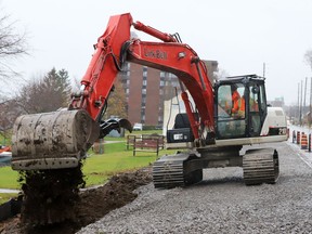 Kris Cunningham, of L.A. Knapp Construction, moves earth to support a planned parking area at Centeen Park on a rainy Wednesday afternoon. (RONALD ZAJAC/The Recorder and Times)