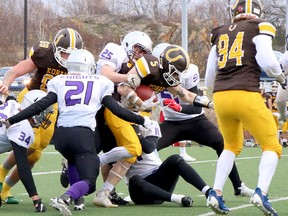 Gabe Byron (5) of the Korah Colts is tackled by Massi Grossi (21), Trent Laferriere (22), Matthew Korzeniecki (11) and Jamie Burrell (51) of the Lo-Ellen Park Knights during NOSSA senior boys football semifinal action at James Jerome Sports Complex  on Saturday afternoon.