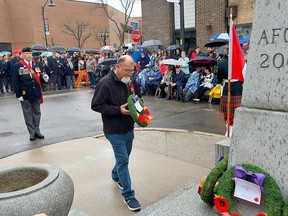 Dan Brant, father of Master Corp. Kristal Giesebrecht, who was killed in the war in Afghanistan, on June 26, 2010, places the first wreath on the cenotaph in downtown Chatham, during Friday's Remembrance Day ceremony. (Ellwood Shreve/Chatham Daily News)
