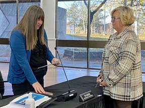 Amanda Brisson, left, realtor and community volunteer, being sworn in to the Cornwall Police Services (CPS) Board by Cornwall clerk Manon Levesque, right, on Thursday November 3, 2022 in Cornwall, Ont. Shawna O'Neill/Cornwall Standard-Freeholder/Postmedia Network