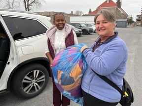 Heather Megill, president of the Rotary Club of Cornwall, will a donation delivery to Djenane Turenne of the ACFO-SDG. Photo on Friday, November 11, 2022, in Cornwall, Ont. Todd Hambleton/Cornwall Standard-Freeholder/Postmedia Network