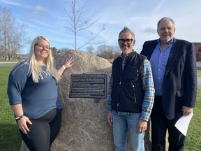 From left to right, SLC Cornwall Student Union president Tori Arnett, SLC president and CEO Glenn Vollebregt, and Richard Wiggers, dean of SLC Interdisciplinary Studies, Pathways, and the Cornwall campus. The group stands in front of a mental health plaque, with a new oak tree seen in the background, planted in honour of students who lost their lives to suicide. Pictured on Tuesday November 15, 2022 in Cornwall, Ont. Shawna O'Neill/Cornwall Standard-Freeholder/Postmedia Network