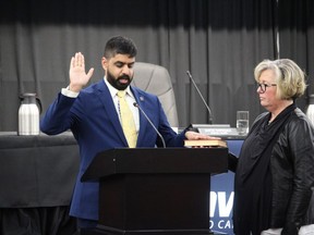 Justin Towndale taking the oath of office, next to clerk Manon Levesque. Photo on Tuesday, November 15, 2022, in Cornwall, Ont. Todd Hambleton/Cornwall Standard-Freeholder/Postmedia Network