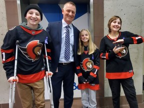From left to right: Emeric Leblanc, Senators director, alumni, community and player relations Aaron Robinson, Kassy and Katy MacLennan before they dropped the puck at the Ottawa Senators game on Wednesday, November 16, 2022. Handout/Cornwall Standard-Freeholder/Postmedia Network