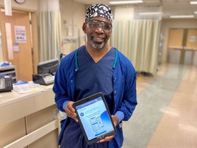 Handout/Cornwall Standard-Freeholder/Postmedia Network
A Cornwall Community Hospital photo of orthopedic surgeon Dr. Chris Raynor, displaying the SeamlessMD app on his iPad, which allows patients to access information before and after their surgery.