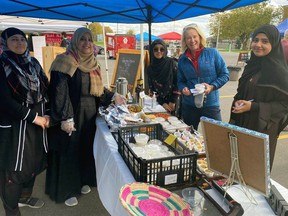 Handout/Cornwall Standard-Freeholder/Postmedia Network
Members of the Cornwall Islamic Foundation serve a customer at the group's table at the Cornwall Kinsmen Farmers Market in October 2022.