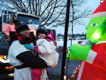 Kirstin Sabourin and Talia Harding-Burch get ready to board with the Grinch on the Southbridge (Parisien Manor) Long-term Care float before the start of the Santa Claus Parade on Saturday November 19, 2022 in Cornwall, Ont. Greg Peerenboom/Special to the Cornwall Standard-Freeholder/Postmedia Network