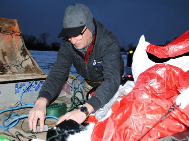 Travis Parisien attaches the Christmas lights for the One Call Plumbing and Gas Fitting float before the start of the Santa Claus Parade on Saturday November 19, 2022 in Cornwall, Ont. Greg Peerenboom/Special to the Cornwall Standard-Freeholder/Postmedia Network