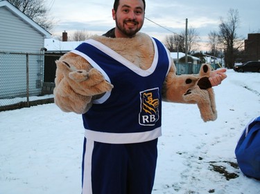 Trent Hambleton gets his mascot costume on for the RBC Dominion Securities float before the start of the Santa Claus Parade on Saturday November 19, 2022 in Cornwall, Ont. Greg Peerenboom/Special to the Cornwall Standard-Freeholder/Postmedia Network
