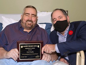 Handout/Cornwall Standard-Freeholder/Postmedia Network
Children's Treatment Centre president David Michaud, left, presents David Murphy with a plaque honouring him with a President's Award, on Nov. 8, 2022.