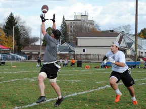 Budweiser's Alan Wheeler goes up for a pass from Thor Grant with Co-operators Jakob Loucks in hot pursuit during the final of the Cornwall Men's Flag Football League on Saturday November 5, 2022 in Cornwall, Ont. Greg Peerenboom/Special to the Cornwall Standard-Freeholder/Postmedia Network