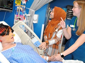 Cornwall Collegiate Vocational School Grade 11 student Muminah Hafizi, left, receives guidance from nursing student Sara Heidringa of Cornwall on a laboratory manikin during the St. Lawrence College open house on Saturday November 5, 2022 in Cornwall, Ont. Greg Peerenboom/Special to the Cornwall Standard-Freeholder/Postmedia Network