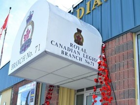 Handmade knit and crocheted poppies are displayed on both sides of the entrance into the High River Legion.