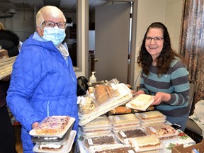 Gwen Pullam of High River buys most of her Christmas baking from hospital volunteer coordinator Grace Ledoux at the High River Hospital Auxiliary Bake and Craft Sale, which was held on Saturday, Nov. 19th at the Masonic Hall in High River. Photo by Dana Zielke