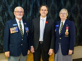 Bob Collins, Mayor Craig Snodgrass, and Legion president Linda Reed pose after the mayor received the first poppy in High River on Friday, Oct. 28, 2022. Officials around Canada receive the first poppy each year to start the poppy campaign.