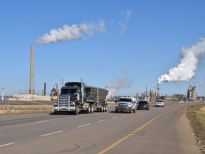 Vehicles drive south on Highway 63 from Syncrude's  Mildred Lake plant, north of Fort McMurray, Alta. on Tuesday September 27, 2016. Cullen Bird/Fort McMurray Today/Postmedia Network